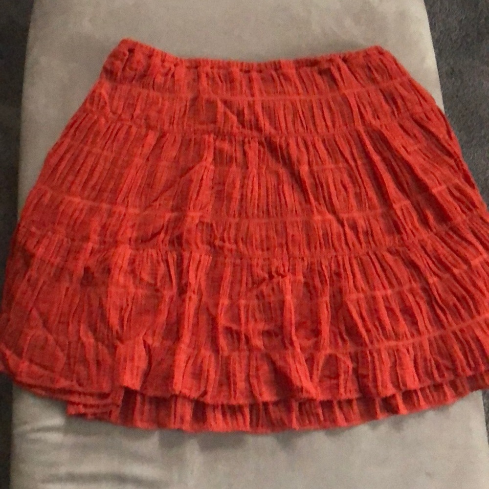 Orange ruffled skirt.
